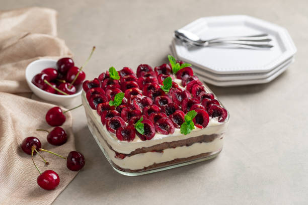 Traditional Italian dessert tiramisu with cherries and mascarpone stock photo