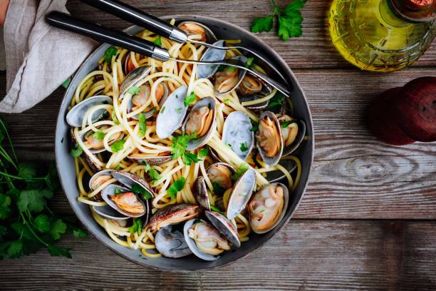 Traditional italian seafood pasta with clams Spaghetti alle Vongole in the pan stock photo