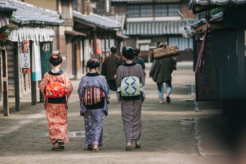 People walking in traditional Edo period town in Kyoto.