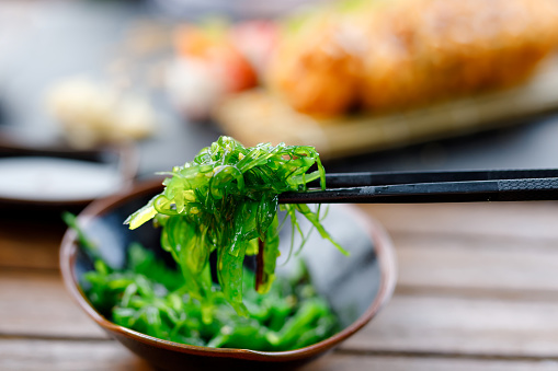 Traditional Japanese wakame salad with sesam seeds. Healthy and fresh seaweed salad. Vegan and organic food