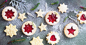 istock Traditional Linzer Christmas cookies with raspberry jam on green stone background. Top view. Flat lay. Festive decoration. 1277311493