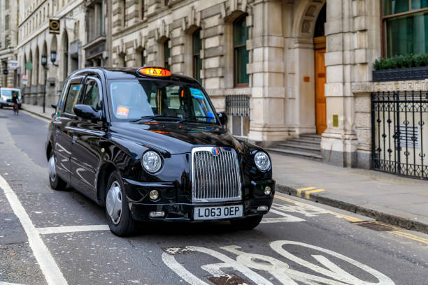 Traditional London black hackney cab or carriage in an empty street in central London, United Kingdom stock photo