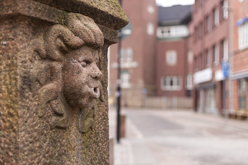 Halmstad, Halland, Sweden - February 13, 2022: Image was taken in the midday of 13th February 2022, in the center of the city. Image presents traditional old fountain in the city centre of Halmstad