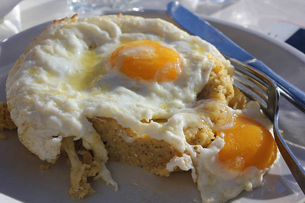 Traditional Polenta Taragna with eggs stock photo