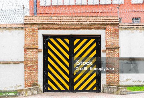 istock Traditional prison doors and concrete walls 1425100236