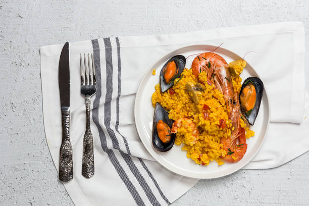 Traditional rice in paella with fish and meat. stock photo