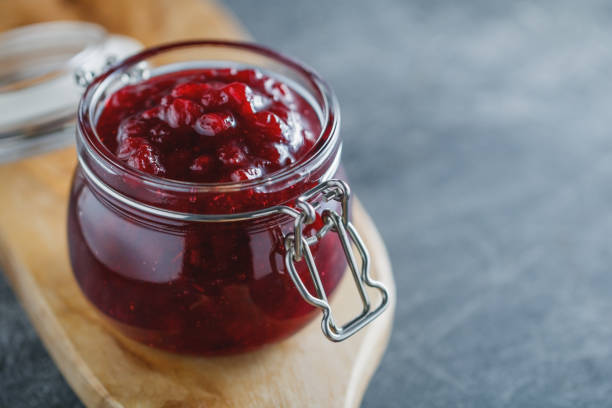 Traditional scandinavian jam with cowberry and juniper Traditional scandinavian jam with cowberry and juniper marmalade stock pictures, royalty-free photos & images