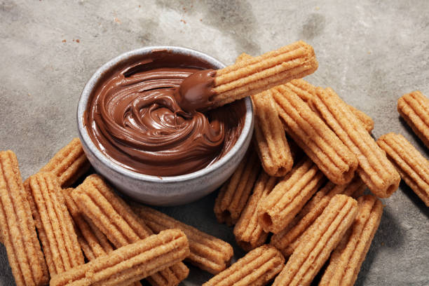 Traditional Spanish dessert churros with sugar and chocolate stock photo