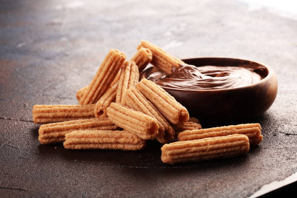 Traditional Spanish dessert churros with sugar and sweet chocolate stock photo