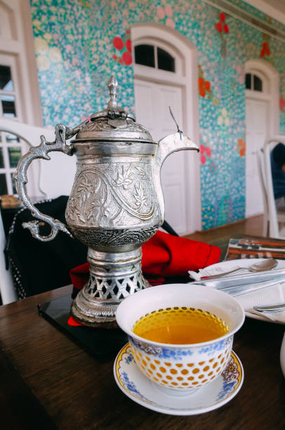 Traditional tea pot with cup of tea Metal tea pot, tea ceremony, Kashmiri kahwa tea jammu and kashmir stock pictures, royalty-free photos & images