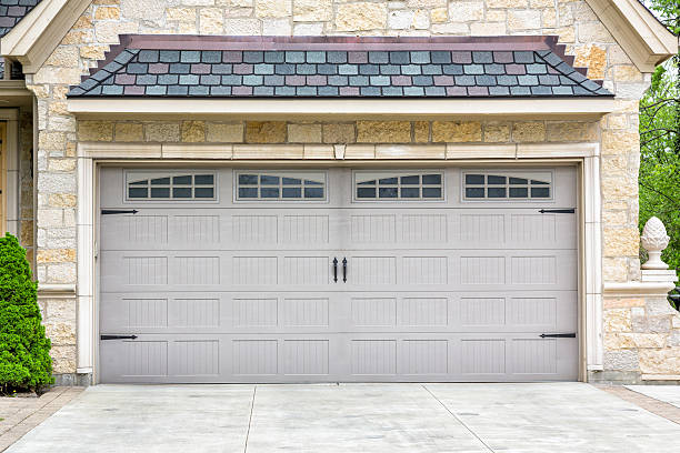 Traditional two car garage with windows and grey panels stock photo