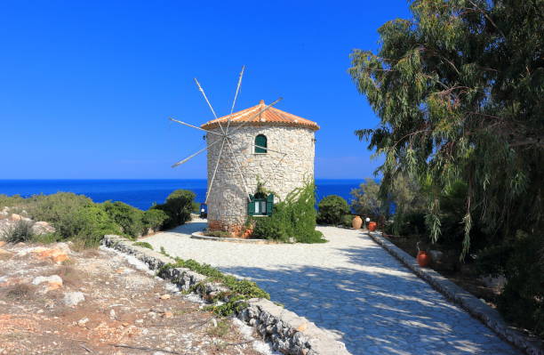 Traditional Windmill in Cape Skinari. North coast of Zakynthos or Zante island, Ionian Sea, Greece. stock photo