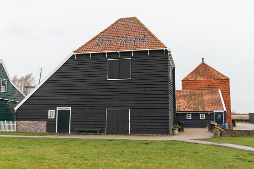 Zaanse Schans, Netherlands - February 25, 2017: Traditional wooden houses and barns of Zaanse Schans historic town, popular tourist attraction of Netherlands