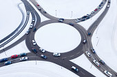 Aerial view of a busy roundabout with traffic in winter.