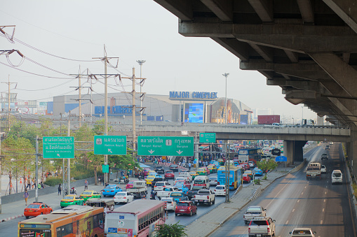Traffic jam on multilane road below and aside elevated highway in Bangkok Rangsit at Future park