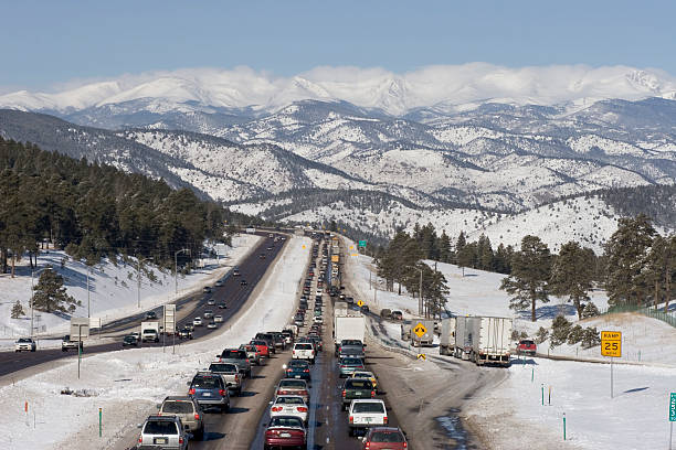 Traffic jam westbound I-70 highway with snow covered mountains Colorado stock photo