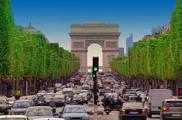 traffic jam with cars in Paris city, France. view of Arc de Triomphe stock photo