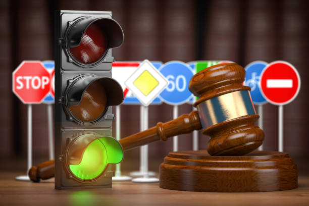 Traffic law concept. Judge gavel with traffic lights and traffic signs. stock photo