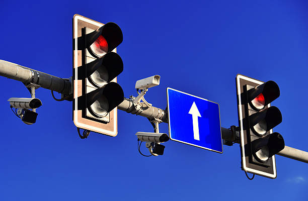 Traffic lights over blue sky stock photo