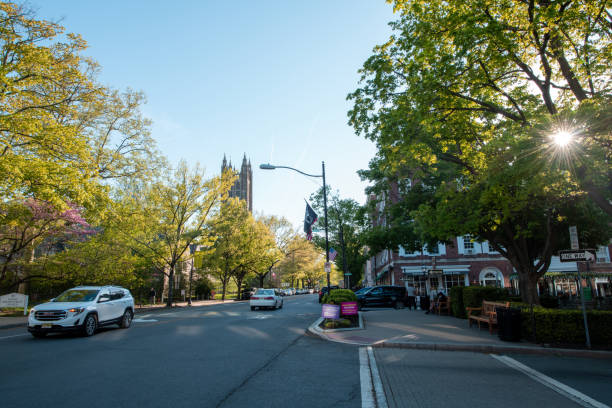 Traffic on street with people walking on sidewalk in downtown Princeton stock photo