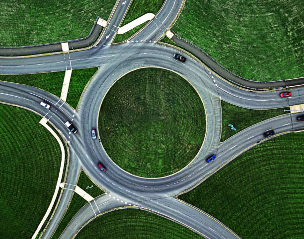 Traffic Roundabout Below Aerial view of a traffic roundabout. drone photos stock pictures, royalty-free photos & images