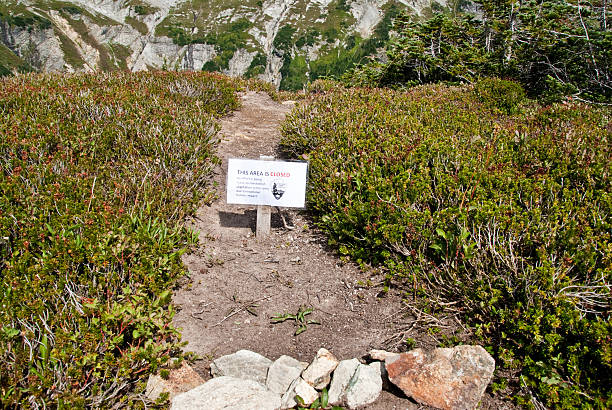 Sign to Advise of Trail Closure North Cascades National Park, Washington, USA - August 22, 2009: A trail sign at Sahale Arm is used to advise hikers of a closure due to environmental damage. jeff goulden environmental conservation stock pictures, royalty-free photos & images
