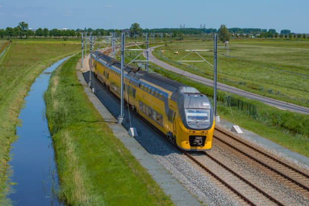 Train of the Dutch railways driving over the Hanzelijn railroad during springtime stock photo