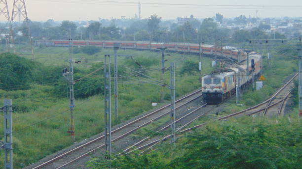 Train on curve Tata Steel Livery WAP7 37026 Hauled 12859 Mumbai CSMT Howrah Geetanjali SF Express stock photo