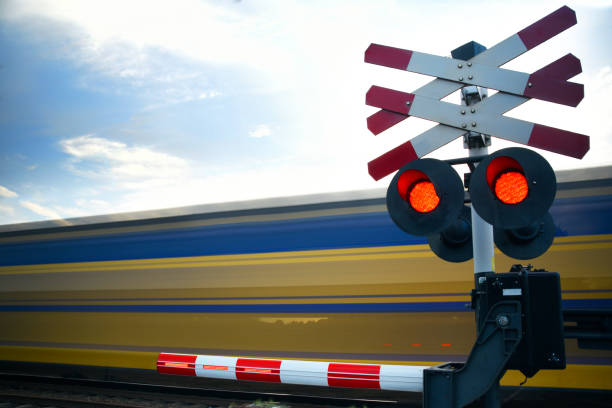 Train railroad crossing with passing high speed riding train stock photo