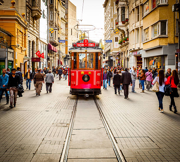 tram drives along shoppers crowding i̇stiklal avenue istanbul - beyoglu stockfoto's en -beelden