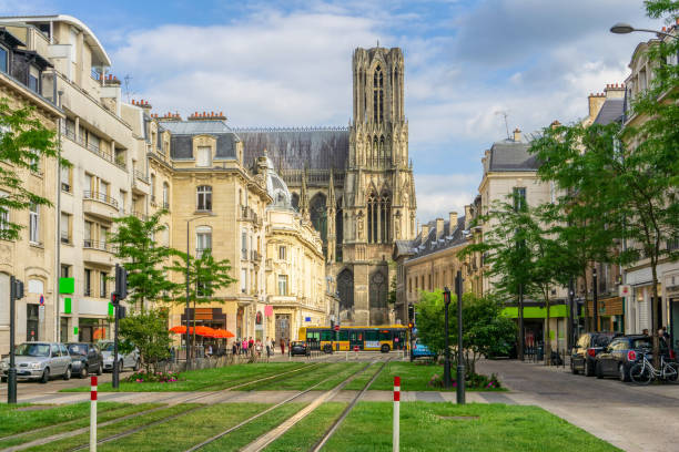 Tram on the streets and Architecture of Reims a city in the Champagne-Ardenne region of France. stock photo
