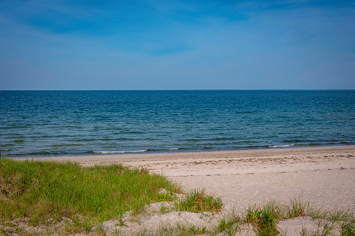 Cape Cod beachscape in the summer before holidays. Clean and quiet bay scenery in the early morning.