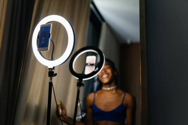 Trans using a led ring for a live on social media stock photo