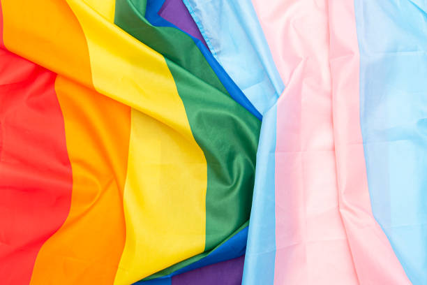 Transgender and gay rainbow flags, fabric LGBT and transgender pride flag as background stock photo