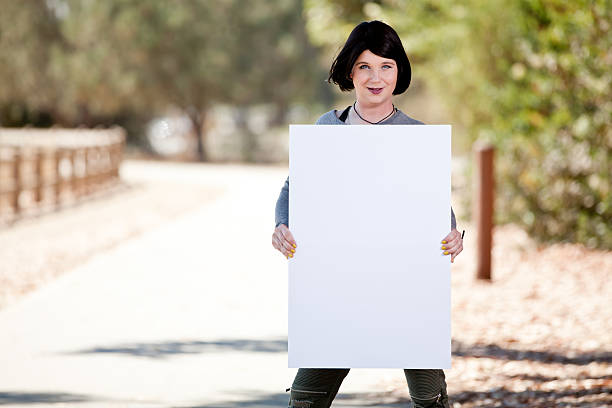 Transgender male to female holding blank sign stock photo
