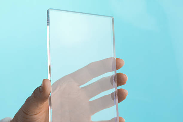 crop hand of a person holding a blank perspex plexiglass 