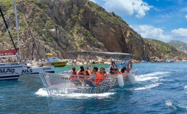 Transparent boat trour to Arch of Cabo San Lucas, El Arco, close to Playa Amantes, Lovers Beach known as Playa Del Amor and Playa del Divorcio, Divorce Beach stock photo