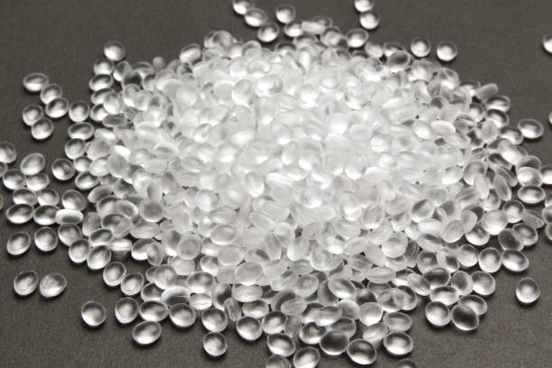 Transparent Polyethylene granules on dark .HDPE Plastic pellets.  Plastic Raw material . IDPE. stock photo