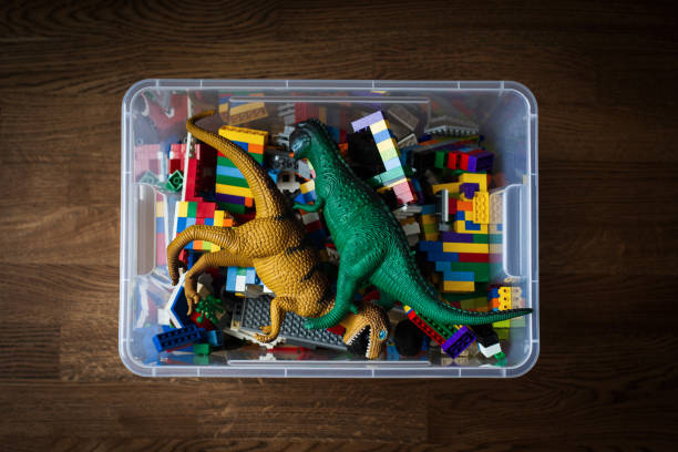 transparent toy container with colored bricks and dinosaurs stock photo