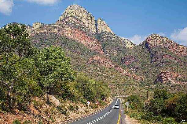 Travel by road through imposing mountain range stock photo