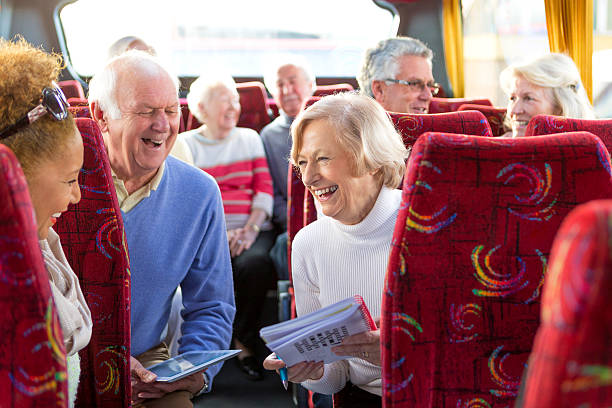 Elderly couple doing crossword on coach journey.