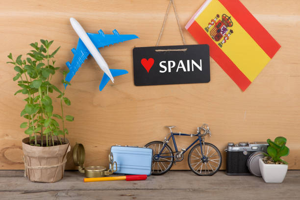 Travel time - blackboard with text "Love Spain", flag of the Spain, airplane model, camera, bicycle stock photo