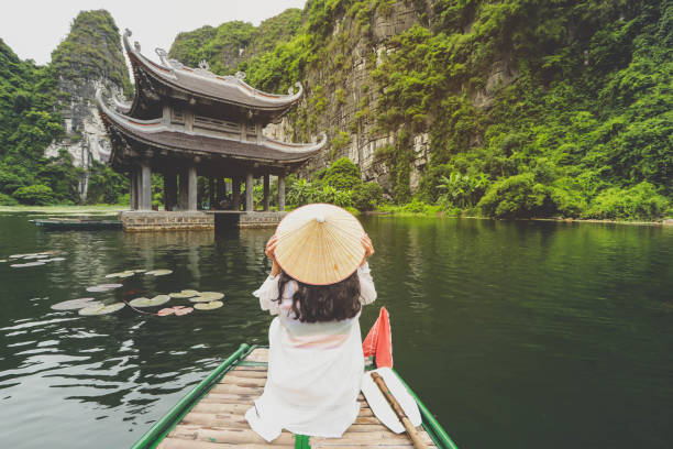 Traveler on boat enjoying  the scenery in Ninh Binh province, Vietnam stock photo