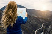 Traveler with world map at mountain