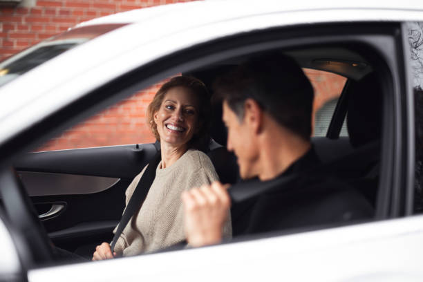 Traveling by car Handsome adult couple is traveling by a car. He is looking at her and smiling. georgijevic frankfurt stock pictures, royalty-free photos & images