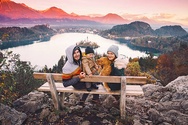 traveling family looking on bled lake, slovenia, europe - castle couple stockfoto's en -beelden