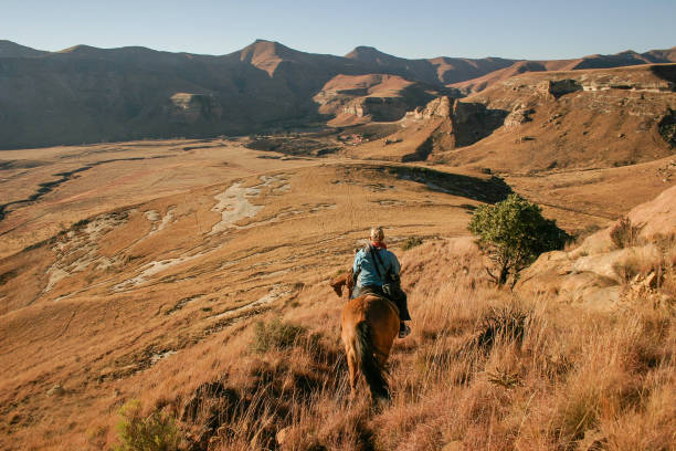 A traveller  on a horse in the Maloti mountains stock photo