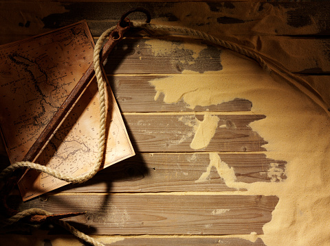Treasure Map and Ships Anchor on Wooden Decking