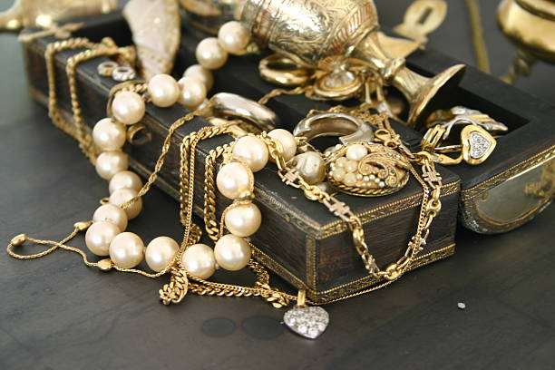 Treasure Jewelry laying over an indian jewelry box.See similar pictures: Jewelry: antique stock pictures, royalty-free photos & images