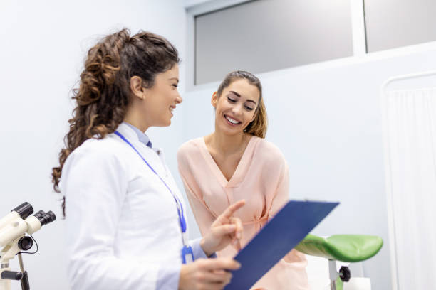 Treatment of cervical disease. Female gynecologist unrecognizable woman patient in gynecological chair during gynecological check up. Gynecologist examines a woman. Diagnostic, medical service. stock photo